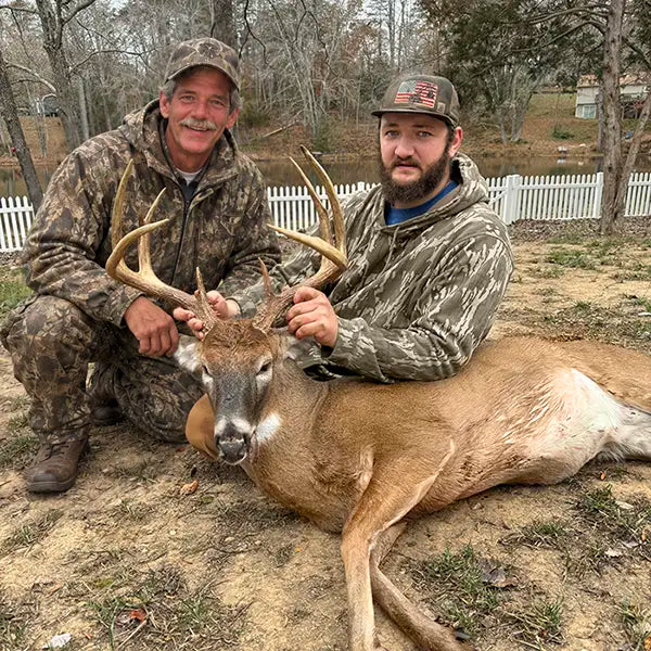 Deceased father added to his son's deer hunting photo, kneeling beside him after the hunt