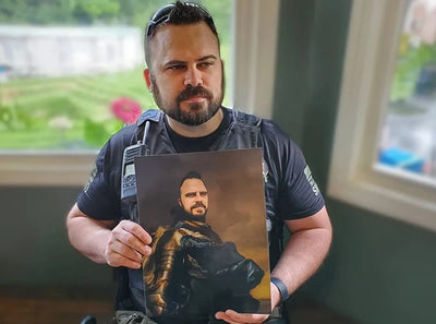  A man in uniform proudly holds a custom Renaissance-style portrait of himself