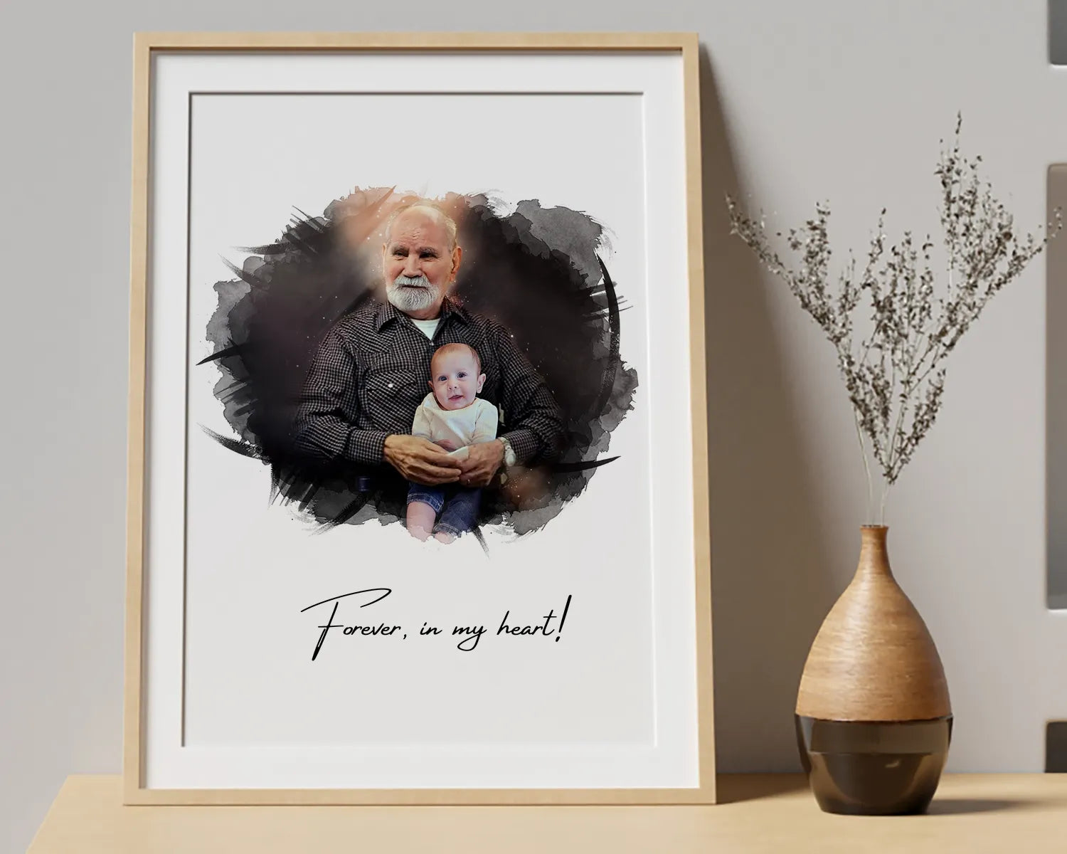 Framed remembrance portrait of a grandfather holding a baby, with text reading ‘Forever, in my heart!’.