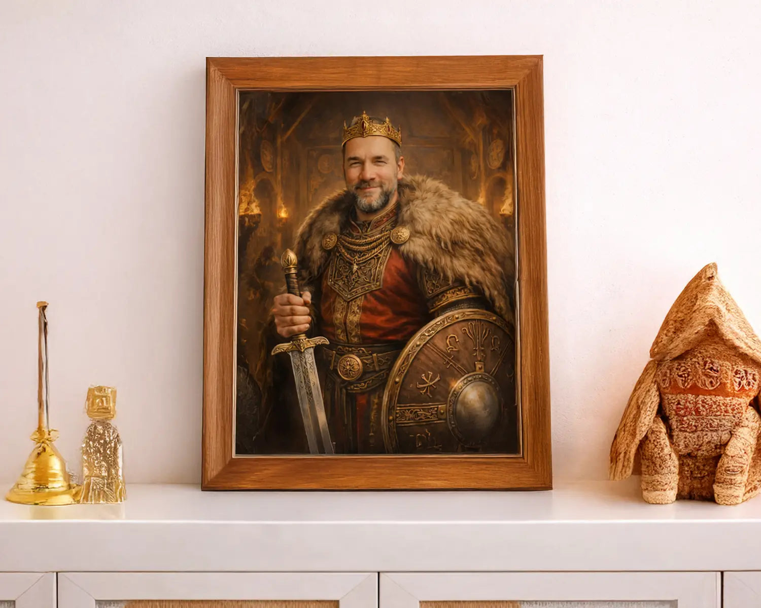 Framed viking painting of a warrior holding a sword and shield on a white surface with decorative items.